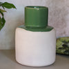 Ceramic vase with green top and white base on a neutral background