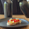 Ceramic oil pourer dressing bruchetta with olive oil